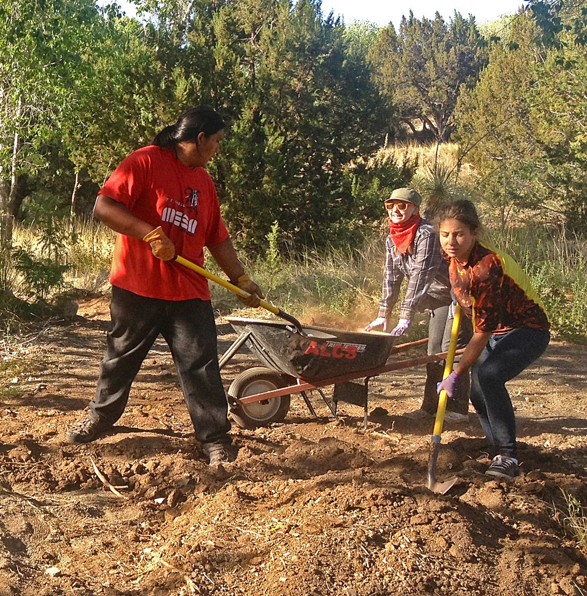 High school volunteers moving dirt