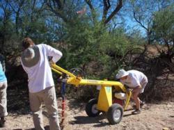 Photo by Chang You. Used with permission - Volunteers use an auger to break up soil.