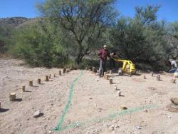 Photo by Nathan Jackson  Volunteers put the final touches on a nearly finished section of the creek deflector project.